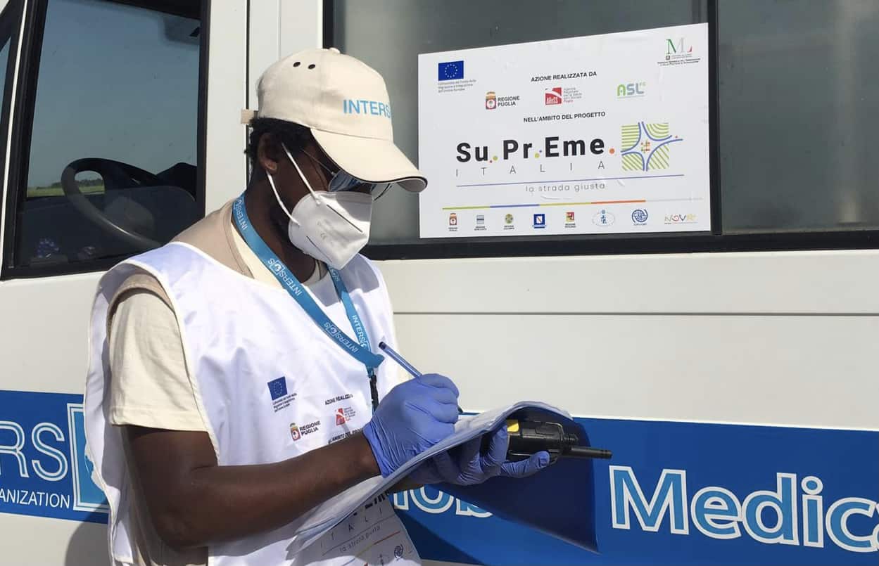Male medic delivering health care to migrant workers in Puglia